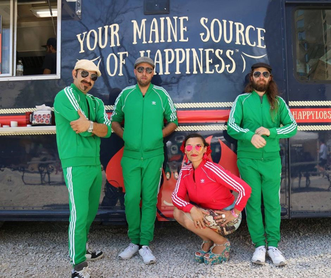 A group of people in green outfits posing for a photoDescription automatically generated