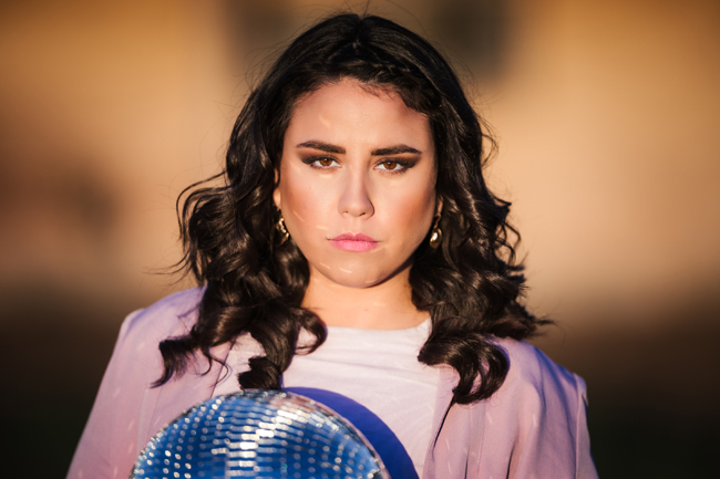 A person holding a disco ball